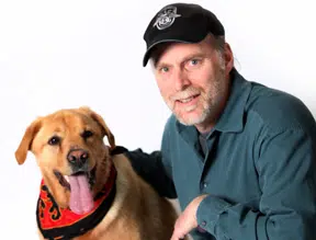 Franchise Owner kneeling with his golden retriever dog