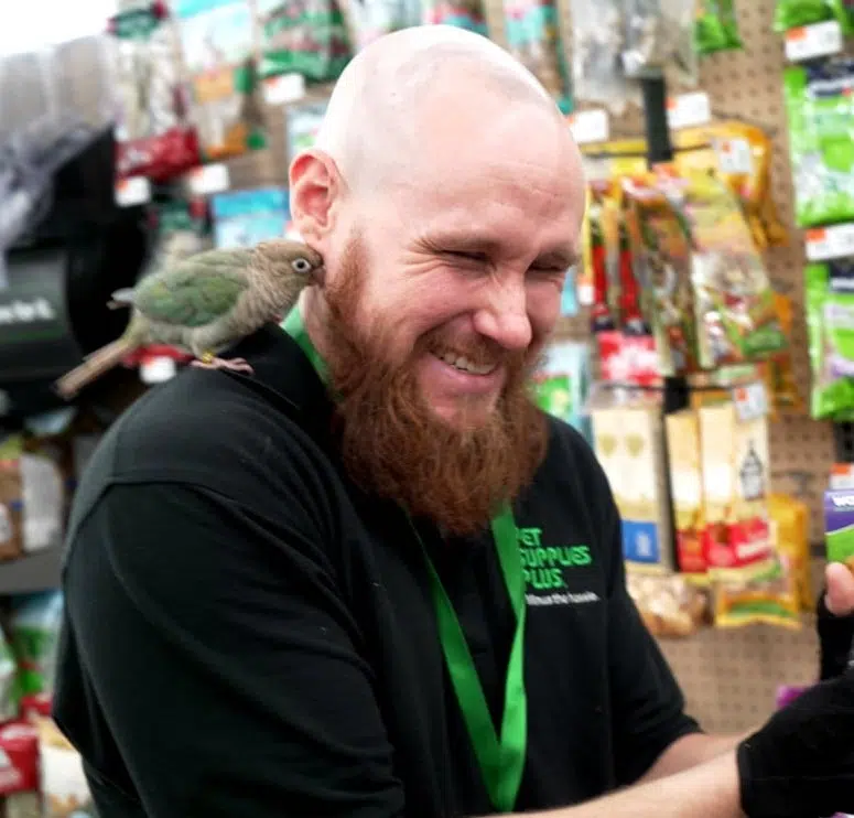 Pet Supplies Plus employee with bird on shoulder